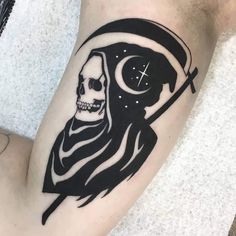 a person with a skull and cross tattoo on their leg