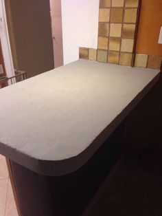 the counter top is made out of concrete