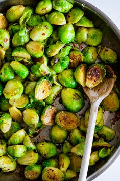 brussel sprouts and brussels sprouts in a pan with a wooden spoon