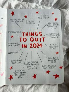 an open notebook with things to quit in 2014 written on the pages and red stars