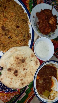 several different types of food on plates with sauces and dips around the plate