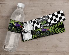 an empty water bottle with a monster truck theme on it and a race car ticket