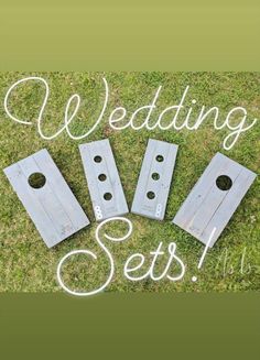 four pieces of wood sitting on top of grass with the words wedding sets written above them