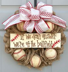 a wreath with baseballs and a sign that says if we don't answer we're the ballfield