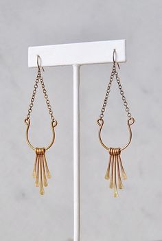 Reflective lightweight dangles combining delicate chain, curved brass wire, and brass fringe swinging beneath. They are a beautiful shape that's both feminine and modern. A definite yes.They hang from nickel free hooks, so they're safe for the ears.More like this: www.etsy.com/listing/673274626► DETAILS:Length: 3.5 inches from top to bottom (9 cm)Materials: Raw brass, Nickel free hooksPackaging: Arrives in a cute box for safe shipping and gift-giving► ALL OF MY JEWELRY: SPARKLEFARM.etsy.com► SHI Elegant Brass Chandelier Earrings With Latkans, Gold Teardrop Tassel Earrings, Elegant Gold Teardrop Tassel Earrings, Brass Tassel Drop Earrings, Elegant Brass Tassel Dangle Earrings, Elegant Brass Tassel Earrings, Long Drop Brass Chandelier Earrings, Elegant Tassel Earrings In Brass, Elegant Brass Earrings With Dangling Charms