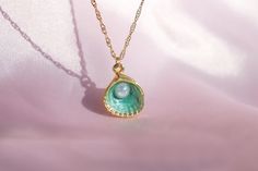 🌊 🐚 In the heart of an underwater kingdom, a green oyster pendant with a shimmering pearl was discovered. This necklace brings a touch of ocean magic and mermaid charm to your everyday style. ✨ 🎁 Your order will arrive in a pre-packaged special and cute box. Ready to be gifted to yourself or someone you care about! 🔍 DETAIL * Material: High quality of Gold Plated Brass * Chain Length: 40 +5 cm / 15.75 +1.95 inches (At the chain's end there is a + 5cm/1.9 inch extension) 📦 SHIPPING * Our pro Green Pearl Drop Necklace Gift, Green Pearl Drop Necklace For Gift, Ocean-inspired Shell-shaped Jewelry Gift, Pearl Charm Jewelry For May Birthstone Gift, May Birthstone Jewelry With Pearl Charm As Gift, Pearl Pendant Jewelry For May Birthstone Gift, Ocean-inspired Pearl Pendant Jewelry, Green Pearl Pendant Jewelry Gift, Green Pearl Drop Jewelry As Gift