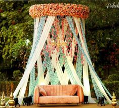 a couch sitting under a canopy covered in flowers