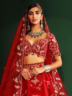 Editor's Note Sindoori Red Embroidered Lehenga In Velvet, Embroidered Blouse And Embroidered Dupatta With Hand Made Tassels Fabric: Velvet, Organza, Shantoon, Cancan Color: Red Components: Lehenga, Blouse And Dupatta Care: Dry Clean Only About the Designer Mahima Mahajan has injected a breath of fresh air into the Indian fashion industry with her bespoke collection of decorous designs. Her approach to designing can be described as both fashionable as well as functional. The designs applied by Ma Red Outfits For Women, Mahima Mahajan, Blouse Yoke, Velvet Bustier, Red Outfits, Velvet Lehenga, Bridal Lehenga Red, Gold Fringe, Red Lehenga