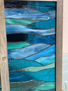 a wooden frame holding a stained glass window