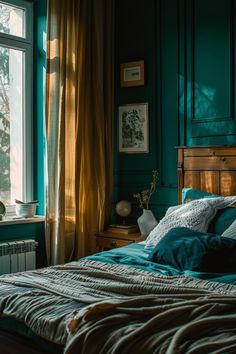 a bedroom with teal walls and wooden bed frame, blue comforter on the bottom