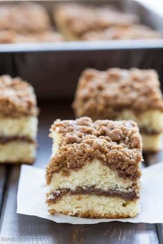 two pieces of cake sitting next to each other on top of a paper towel in front of a pan