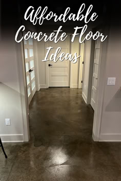 A hallway with dark stained concrete floors, white doors, and neutral-colored walls, with the text "Affordable Concrete Floor Ideas" overlaid on the image. The polished concrete floor adds a modern and sleek look to the space. Indoor Remodeling Ideas, Cheapest Flooring Ideas, Concrete Stain Colors Indoor, Stained Concrete Floors Farmhouse, Inexpensive Flooring Ideas, Indoor Concrete Floor Ideas, Stained Cement Floors, Concrete Floor Ideas, Diy Stained Concrete Floors