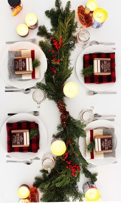 the table is set for christmas dinner with candles and napkins on top of it