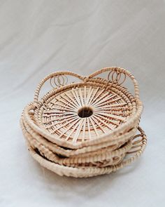 four wicker baskets stacked on top of each other in the shape of a heart