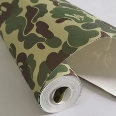 a roll of camouflage paper on top of a white surface