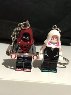 two lego figurines are sitting next to each other