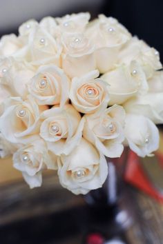 a bouquet of white roses on a table