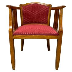 a wooden chair with a red upholstered seat and back cushion on an isolated white background