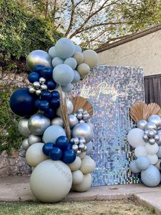 balloons are arranged in the shape of mermaids and seashells on display outside