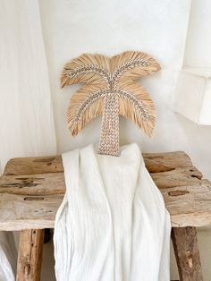 a wooden table with a towel on it and a palm tree made out of wood