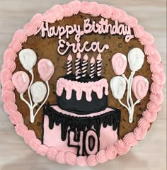 a birthday cake decorated with pink and black icing