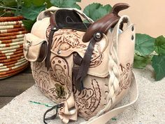 a brown and white purse sitting on top of a table