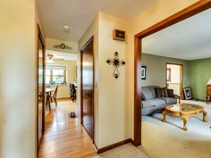 a living room filled with furniture next to a doorway