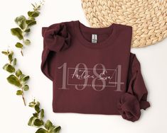 an image of a t - shirt with the number one on it next to some plants