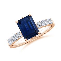 a blue sapphire and diamond ring on a white background