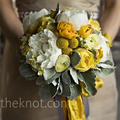 a bridal bouquet with yellow and white flowers