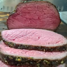 sliced meat sitting on top of a metal pan