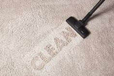 a close up view of a vacuum cleaner on the carpet with its head in the air