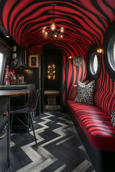 a red and black striped room with round windows