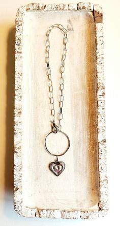 Unique boho chic artisan heart necklace. Hand-soldered artisan made pewter heart charm on a hammered circle and paperclip chain. ~ Approx. 16" - 16-1/2" Long adjustable to shorter lengths ~ Heart is approx. 25mm across / 20mm tall ~ Halo/Circle is approx. 42mm in diameter ~ Pewter, Silver Plate ~ Lobster Clasp ~ Colors may vary due to different computer monitors. Silver Hallmarked Heart Necklace For Valentine's Day, Hallmarked Heart-shaped Necklaces For Valentine's Day, Nickel-free Open Heart Charm Necklace For Valentine's Day, Valentine's Day Heart-shaped Metal Charm Necklace, Silver Heart-shaped Brass Necklace, Artisan Necklace, Silver Jewelry Necklace, Love Valentines, Silver Heart