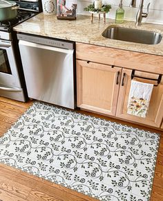 a kitchen area with a sink, dishwasher and stove