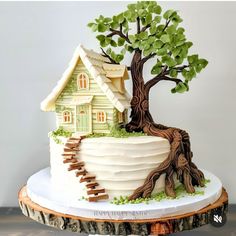 a cake with a tree and house on top