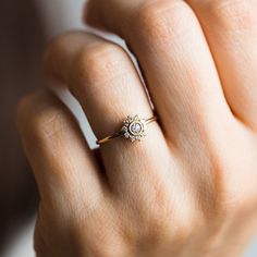 a woman's hand with a diamond ring on it