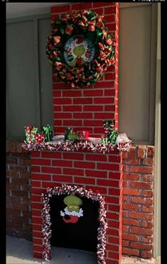 a red brick fireplace with a wreath on top