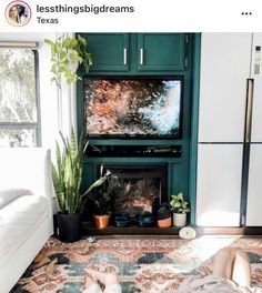 a person laying on the floor in front of a tv with a fire place next to it