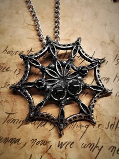 This spiderweb necklace is an handmade pewter sculpture, at first i created it for drows, aka black elves, in role playing games (LARP). The gems are placed like the eyes of spiders. This necklace is sold with a free solid adjustable stainless steel chain This spiderweb is a pendant of 6.5cm diameter This Necklace is a pewter sculpture of my own creation, i create and work the metal by myself at home. The material used is the finest and highest grade hypoallergenic pewter alloy of 98%tin You can Black Metal Fantasy Necklace, Gothic Metal Jewelry For Fantasy Events, Silver Fantasy Necklace With Hand Cast, Black Fantasy Pendant Necklace, Fantasy Black Pendant Necklace, Black Fantasy Necklace For Gift, Black Metal Fantasy Jewelry, Gothic Nickel-free Necklaces, Silver Fantasy Necklace For Halloween