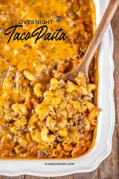 a casserole dish filled with taco pasta and topped with tortilla shells