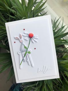 a close up of a greeting card on a plant