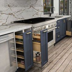 a kitchen with an oven, stove and sink on the wooden floor next to cabinets