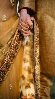 the bride and groom are holding hands