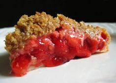 a piece of pie sitting on top of a white plate covered in crumbs