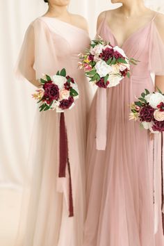 two bridesmaids in pink dresses holding bouquets