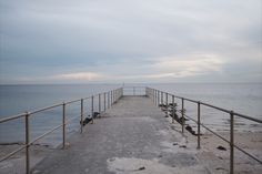 a long pier with benches on the side of it