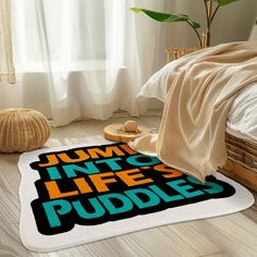 a bed room with a rug that says jump into life's puddles