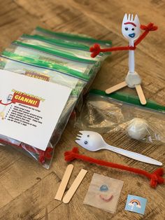 plastic spoons, forks, and other items are on the table with some stickers