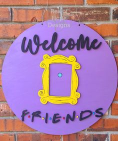 a purple sign that says welcome friends hanging on the side of a brick wall with a yellow frame